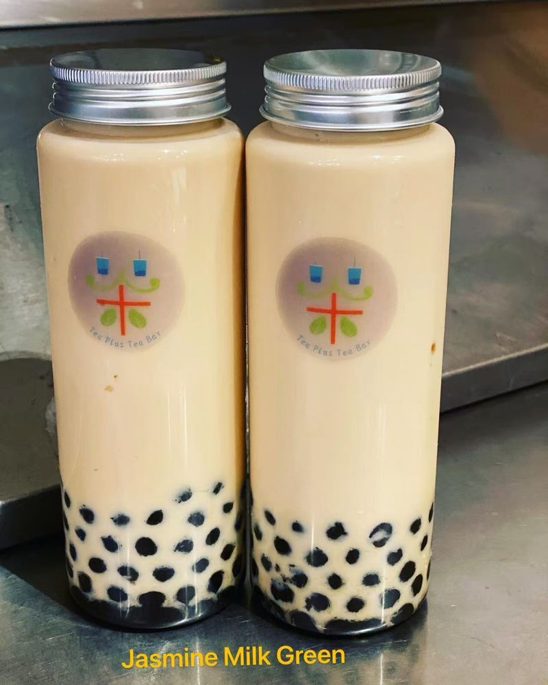 Two bottles of Jasmine Milk Green with boba