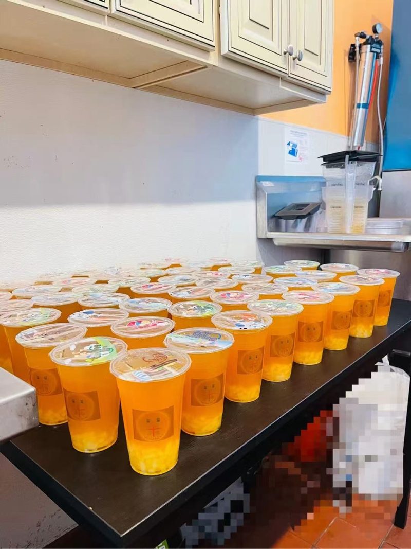 A large catering order of fruit teas covering the counter